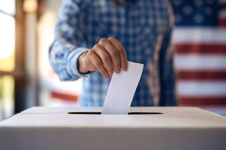 Person Depositing Voting Paper in Ballot Box at Election. EEUU